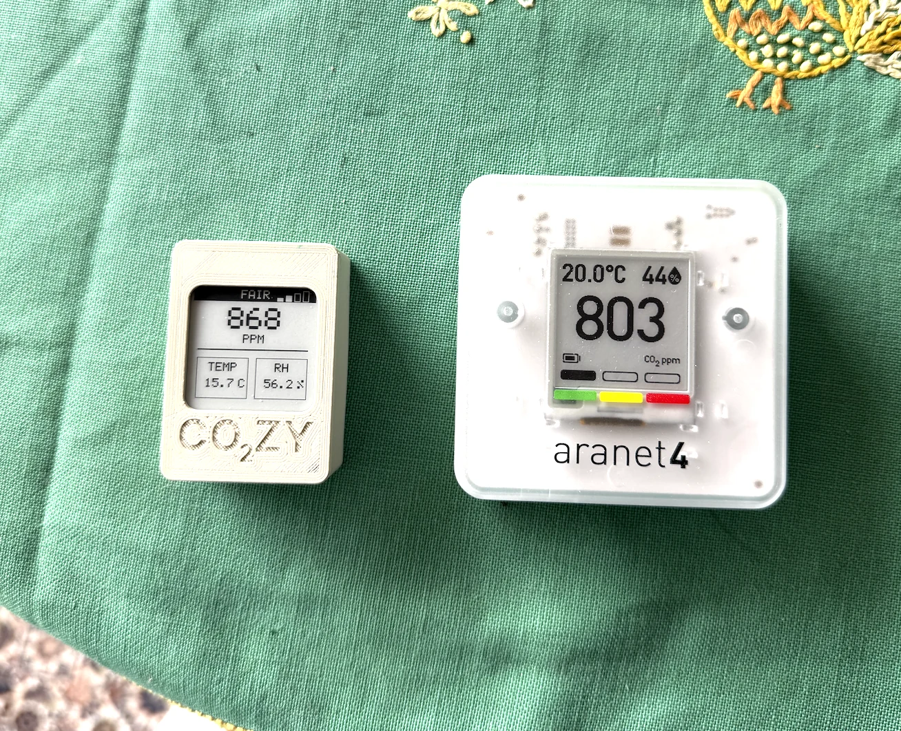 CO₂ZY monitor beside a larger Aranet4 monitor