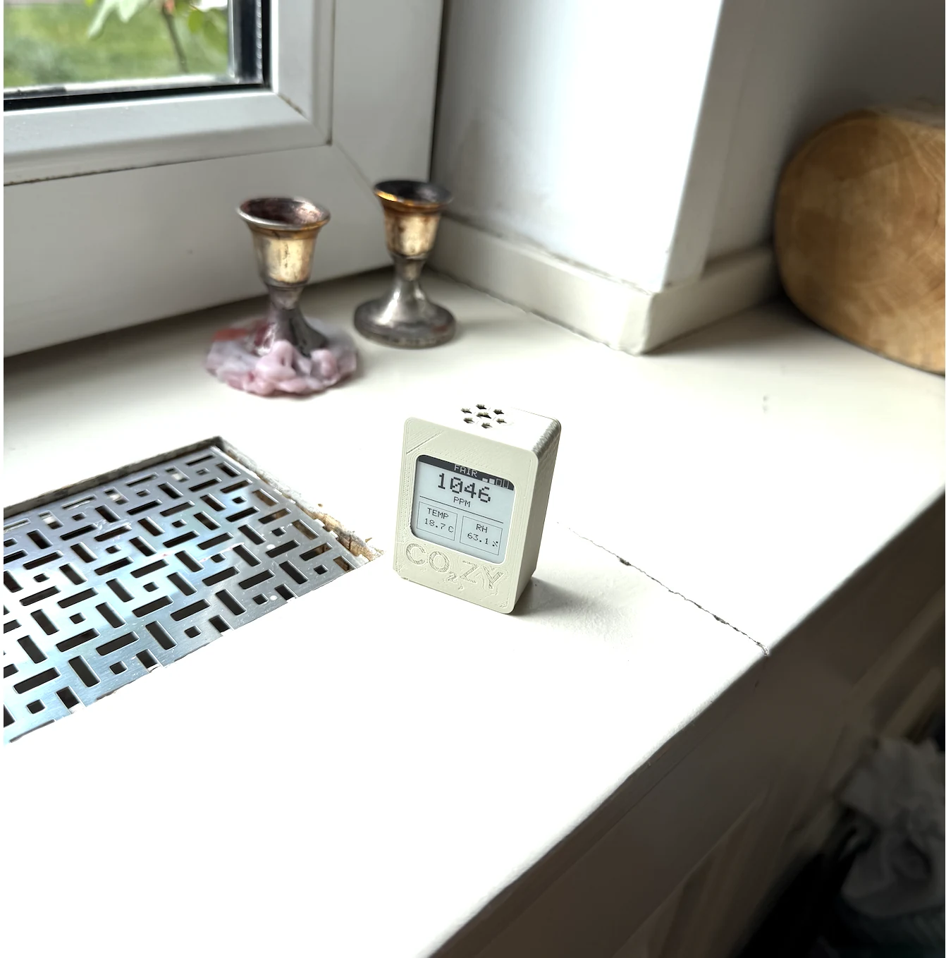 CO₂ZY monitor taking a reading on a windowsill
